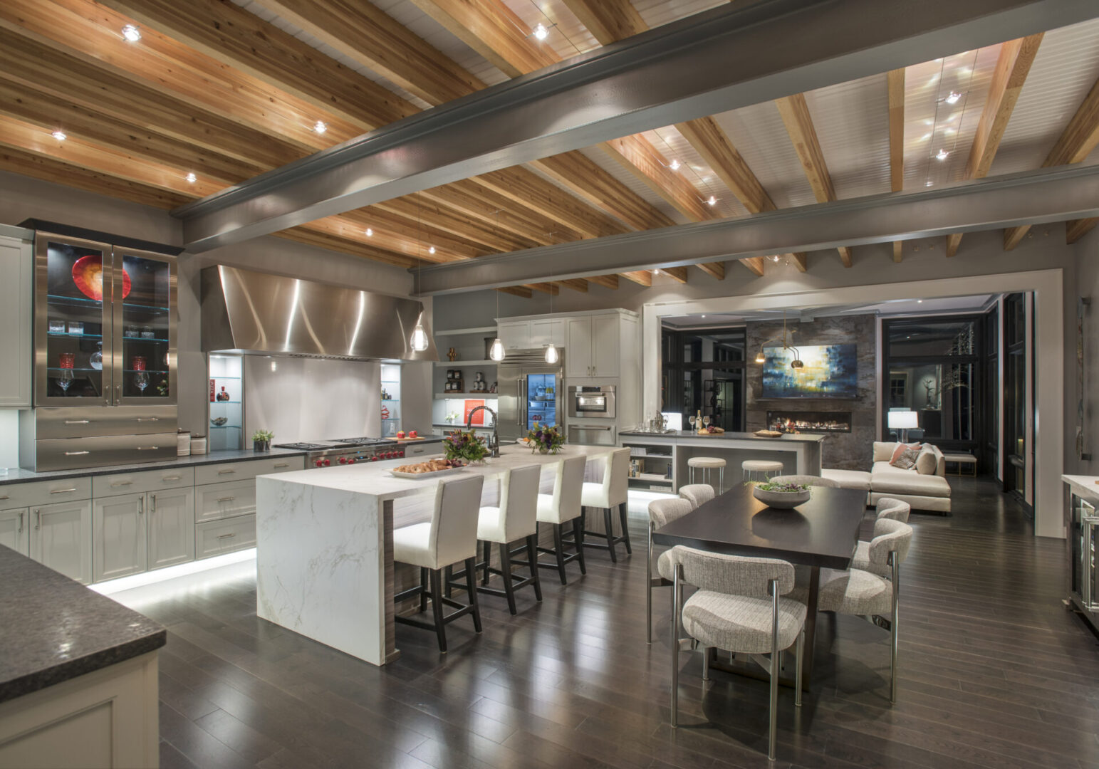 A Kitchen and Dining Space With White Chairs